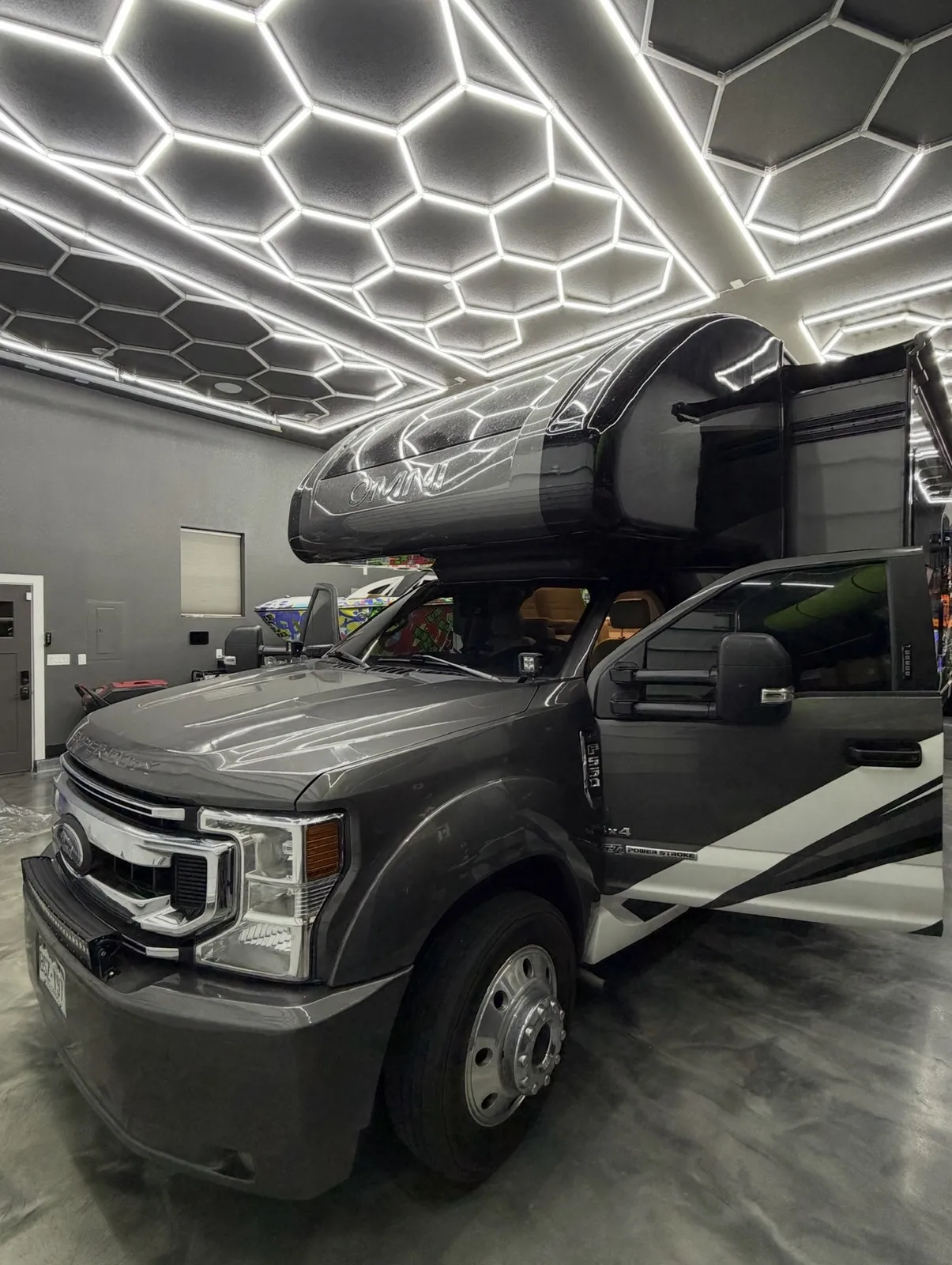 Ford F-150 under the hex ceiling lights after coating work at Precision Tintz