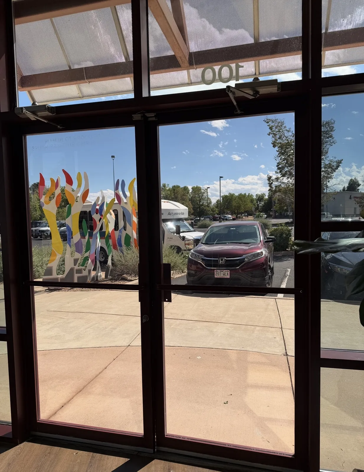 View through freshly filmed commercial storefront glass from inside the suite