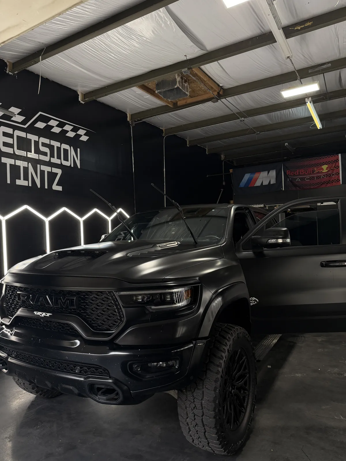 Black RAM TRX in the Precision Tintz bay for window tint and appearance work