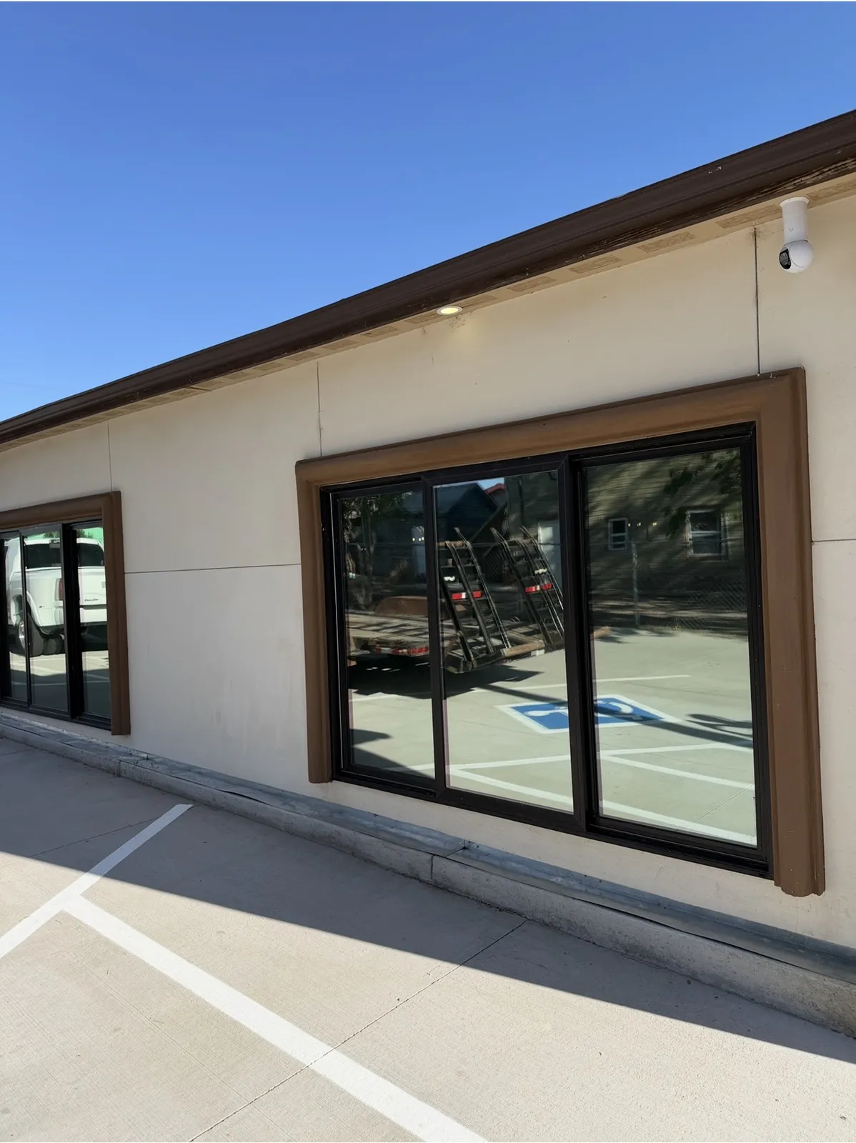 Commercial building with solar window film installed across its storefront glass