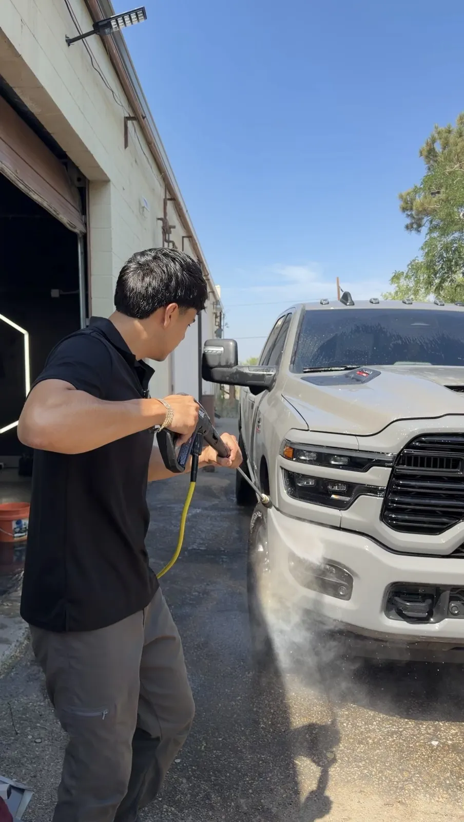 Vehicle receiving a foam pressure wash during an exterior detail at Precision Tintz